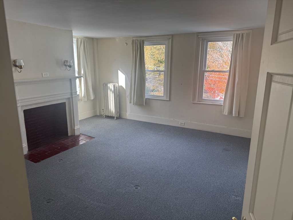 5 Curve Street, Unit 1 Lexington, MA 02420 - Photo 7 of 10 a view of empty room with window and fireplace