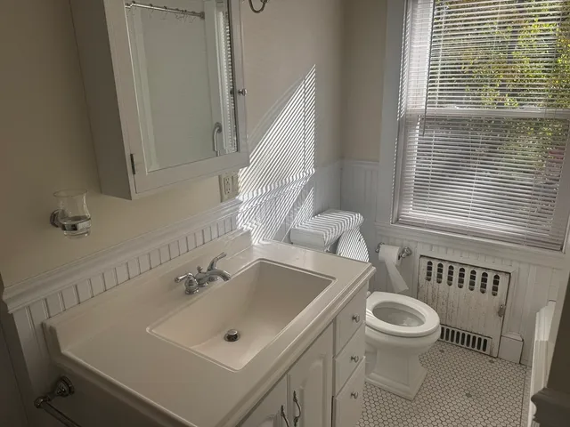 a bathroom with a sink a toilet and tub
