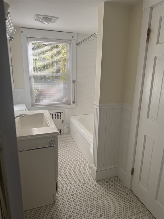 5 Curve Street, Unit 1 Lexington, MA 02420 - Photo 9 of 10 a bathroom with a sink a toilet and tub