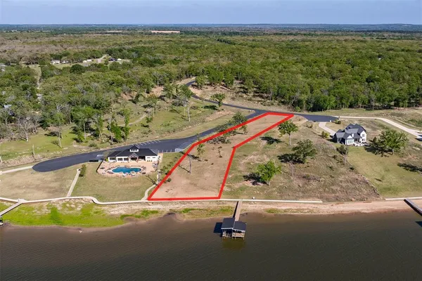 an aerial view of a house with lake view
