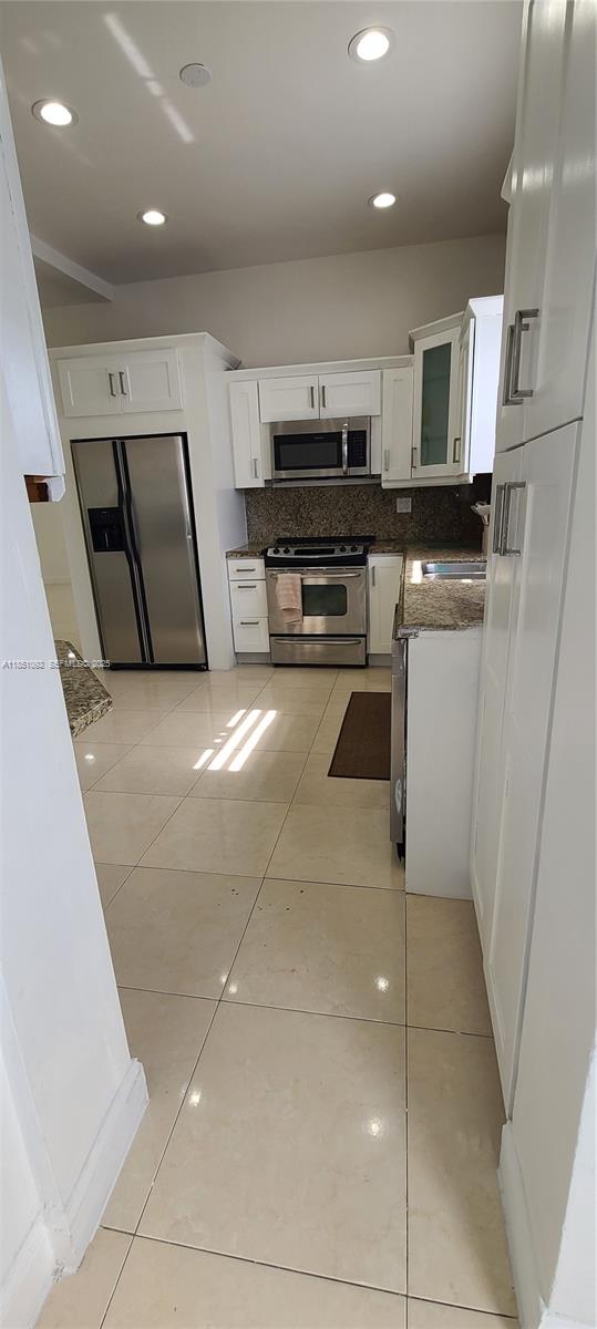 1721 Southwest 24th Terrace Miami, FL 33145 - Photo 23 of 80 a kitchen with stainless steel appliances granite countertop a refrigerator and a sink