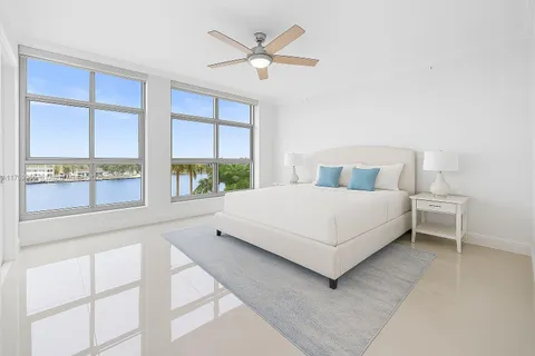 a bedroom with a large bed and a large window