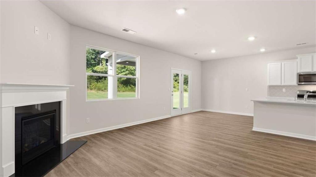 438 Abbott Road Statham, GA 30666 - Photo 21 of 56 a view of an empty room with a window and fireplace