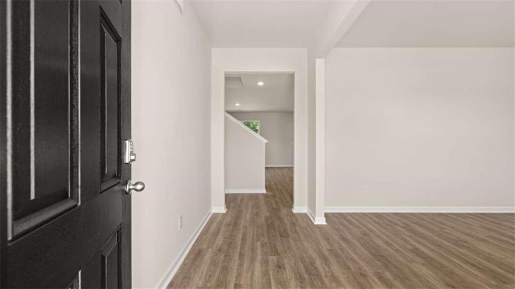 438 Abbott Road Statham, GA 30666 - Photo 23 of 56 a view of a hallway with wooden floor and staircase