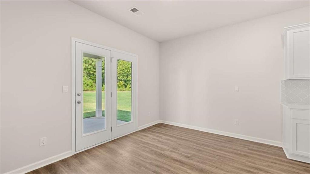 438 Abbott Road Statham, GA 30666 - Photo 24 of 56 a view of an empty room with wooden floor and a window