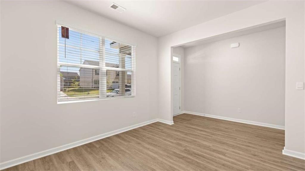 438 Abbott Road Statham, GA 30666 - Photo 25 of 56 a view of an empty room with wooden floor and a window