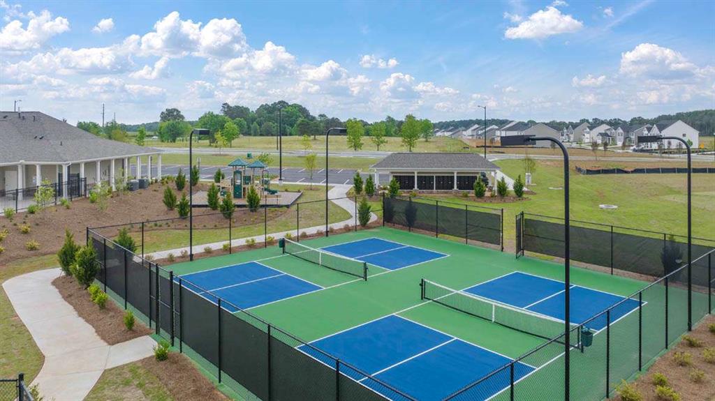 438 Abbott Road Statham, GA 30666 - Photo 6 of 56 a view of a tennis ground with swimming pool and table of chairs