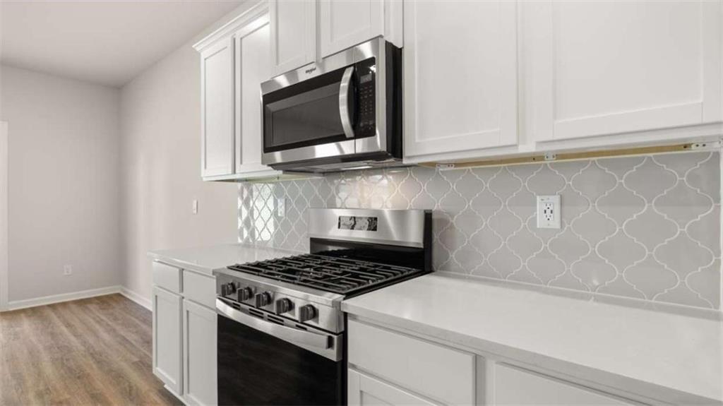 438 Abbott Road Statham, GA 30666 - Photo 10 of 56 a kitchen with microwave cabinets and a stove top oven