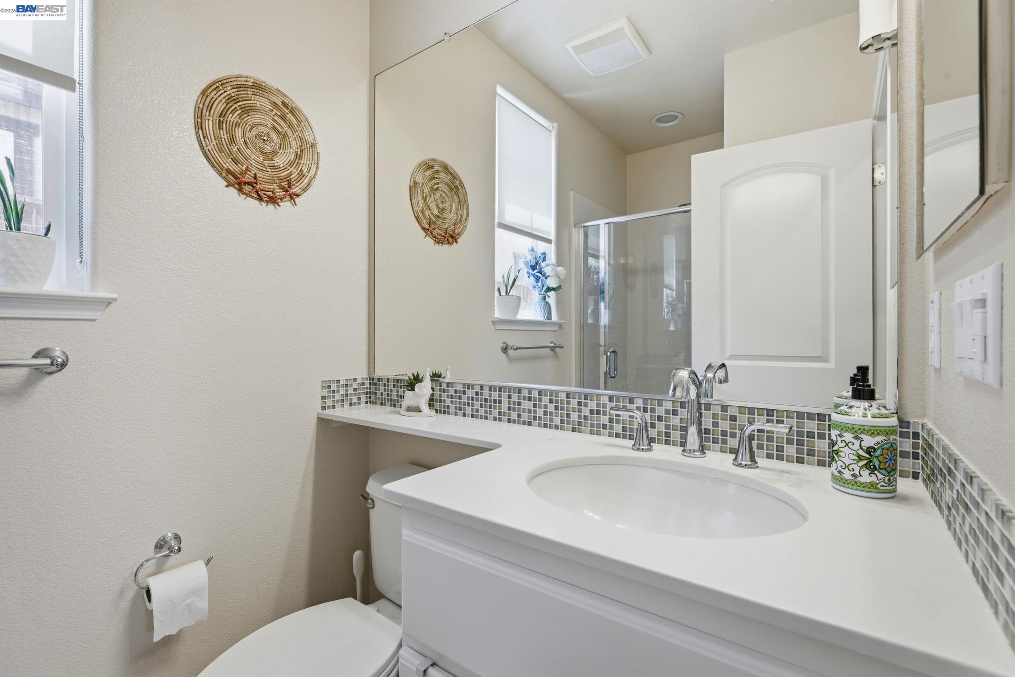 5029 Queensbury Way San Ramon, CA 94582 - Photo 32 of 58 a bathroom with a toilet a sink and a mirror