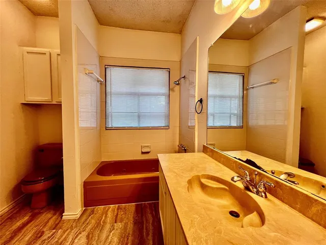 a bathroom with a tub and a sink
