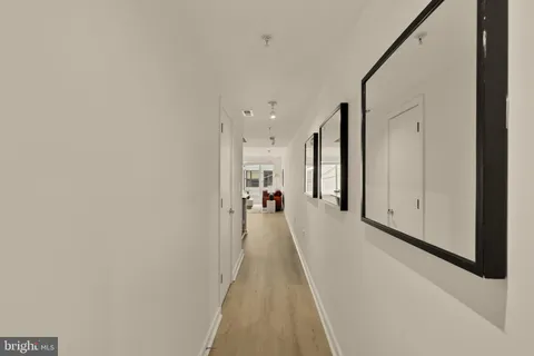 a view of a hallway with a white walls