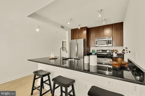 a kitchen with stainless steel appliances a sink and a refrigerator