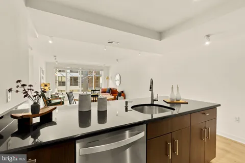 a view of a kitchen with sink and cabinetry