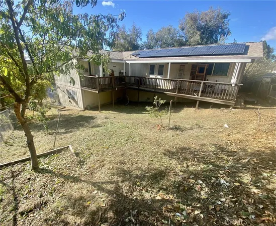a backyard of a house with barbeque oven