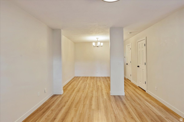 38 South 1000th Street East Payson, UT 84651 - Photo 5 of 19 Spacious interior featuring light wood-finish flooring, white walls, and a contemporary ceiling light fixture