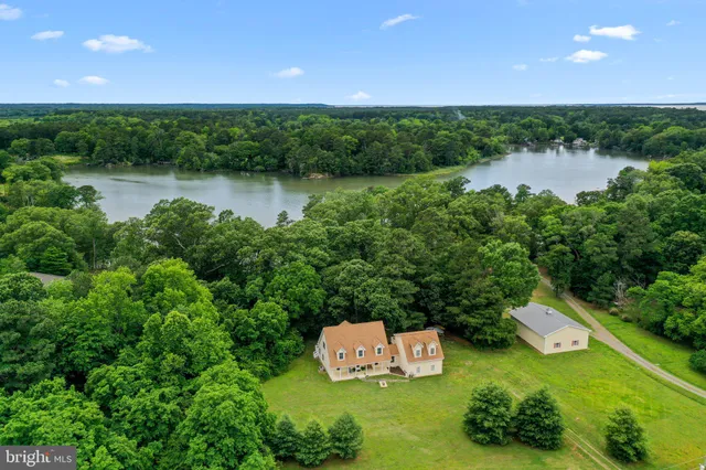 a white house that has a tree in front of it
