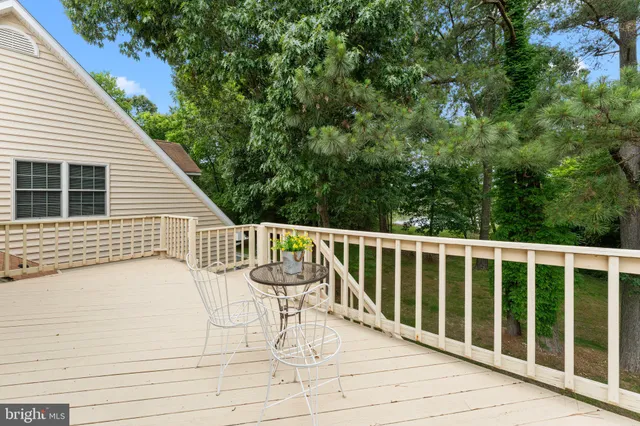 a view of a white house with a yard and sitting area