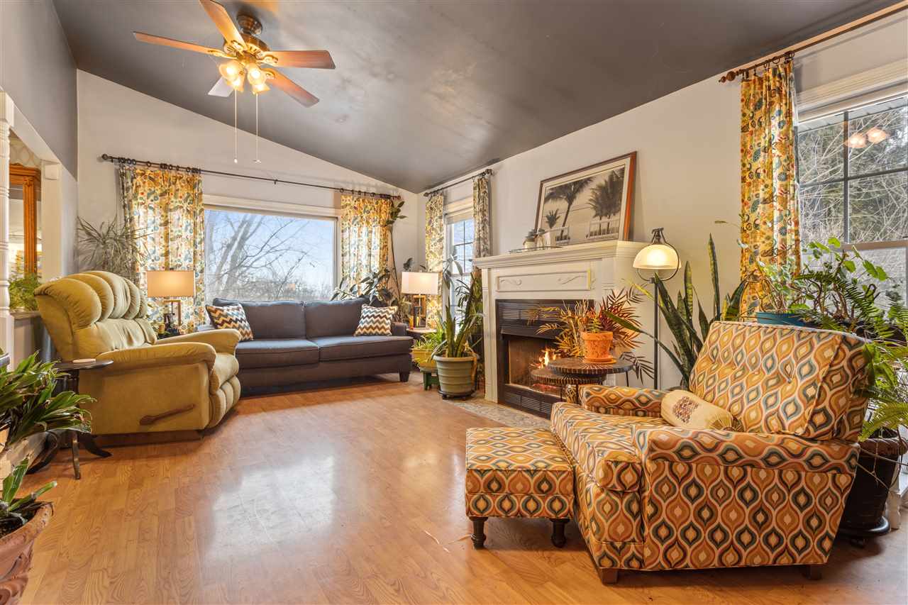 10417 Fruit Farm Road Garden Prairie, IL 61038 - Photo 9 of 25 a living room with furniture a fireplace and a large window