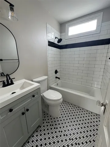 a bathroom with a toilet a sink and bathtub