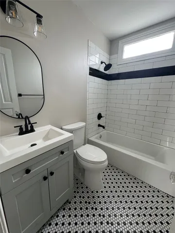 a bathroom with a sink a toilet and a mirror