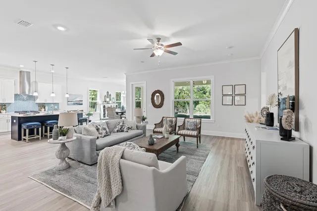a living room with furniture and kitchen view