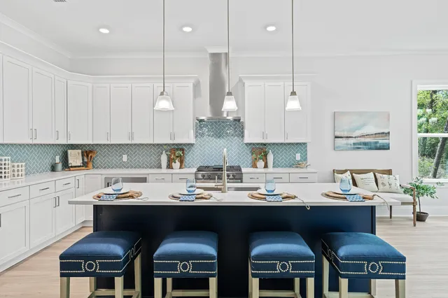 a kitchen with kitchen island granite countertop a sink a counter space and stainless steel appliances