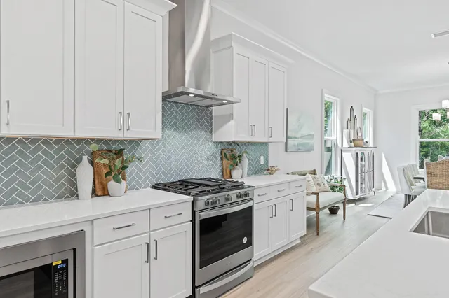 a large kitchen with a table and chairs