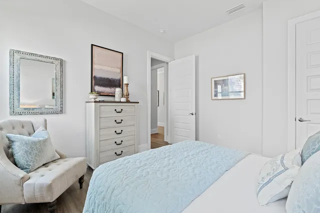 a bedroom with bed and a large window