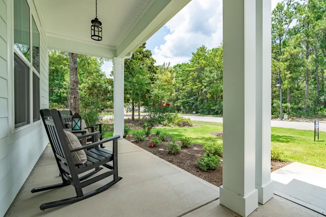 a view of a porch with furniture and a yard