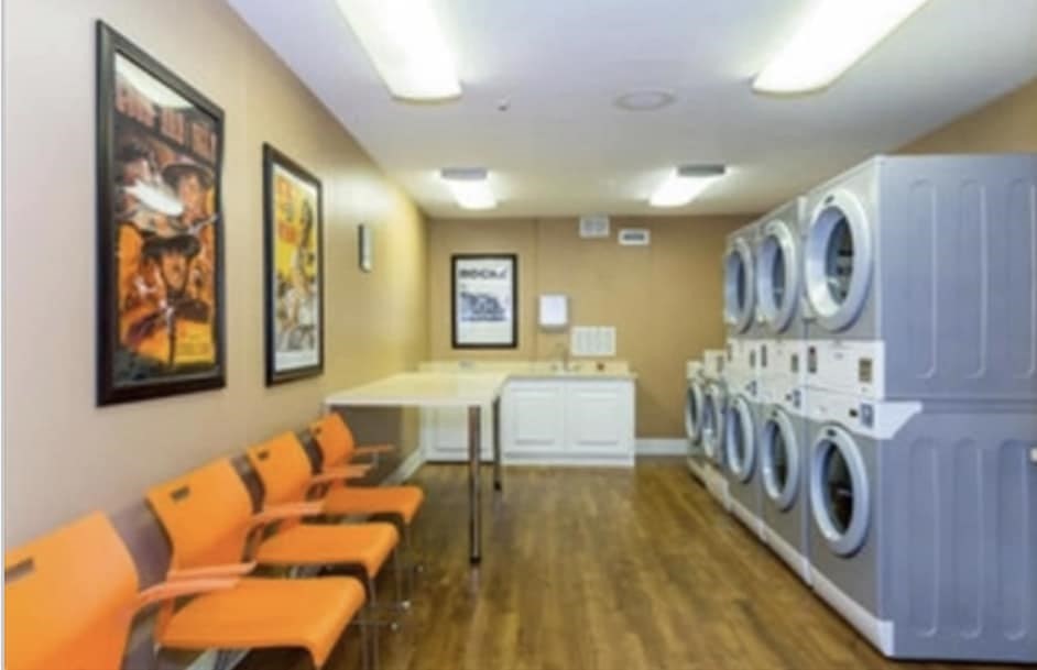 7 Stonehill Drive, Unit 1B Stoneham, MA 02180 - Photo 21 of 21 a bedroom with furniture and a washer dryer