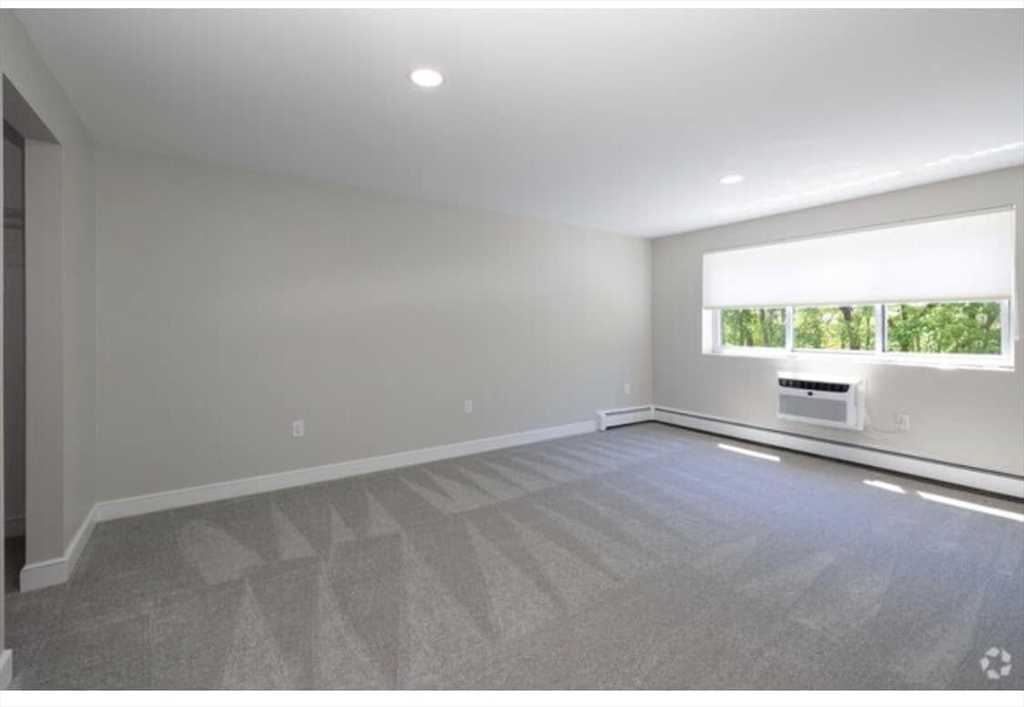 7 Stonehill Drive, Unit 1B Stoneham, MA 02180 - Photo 10 of 21 a view of an empty room with a window