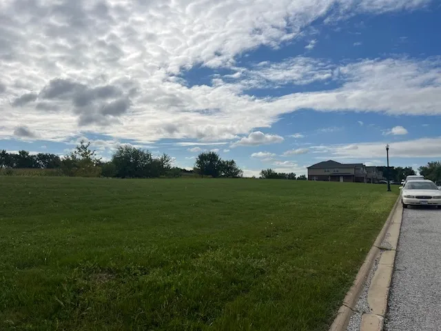 a view of a golf course with outside space