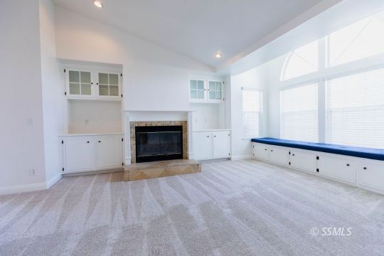 919 Beverly Court Ridgecrest, CA 93555 - Photo 7 of 29 a view of an empty room with a fireplace and a window