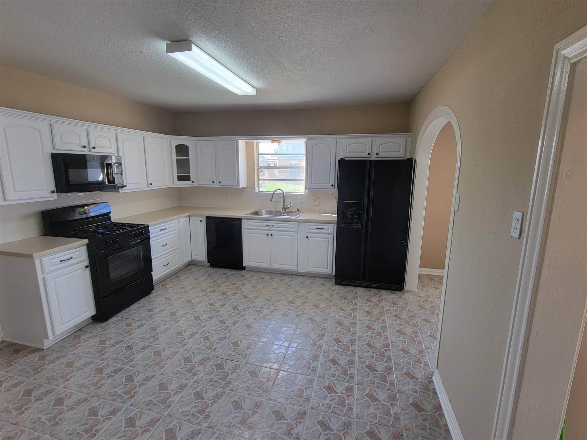 2601 Wheeler Avenue Houston, TX 77004 - Photo 10 of 47 a kitchen with a refrigerator and a stove top oven