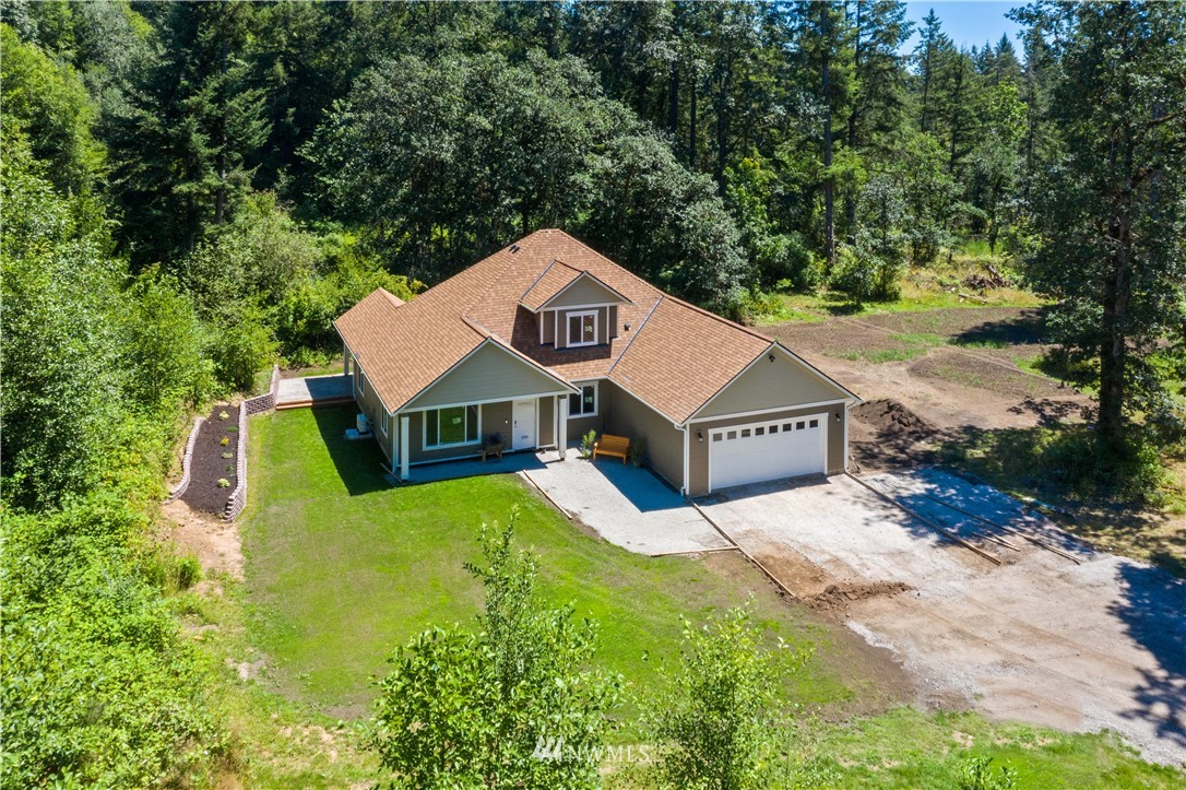 7907 175th Avenue Southwest Rochester, WA 98579 - Photo 1 of 39 a view of a house with a yard and large trees