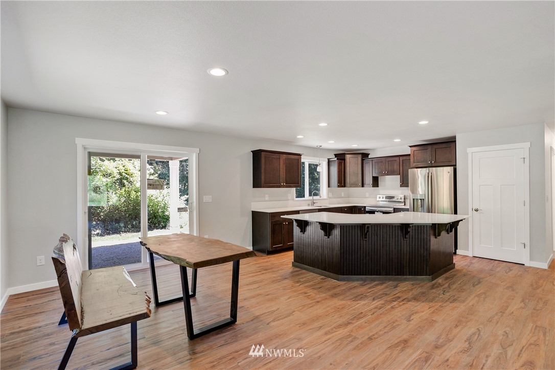 7907 175th Avenue Southwest Rochester, WA 98579 - Photo 19 of 39 a large kitchen with a table and chairs in it