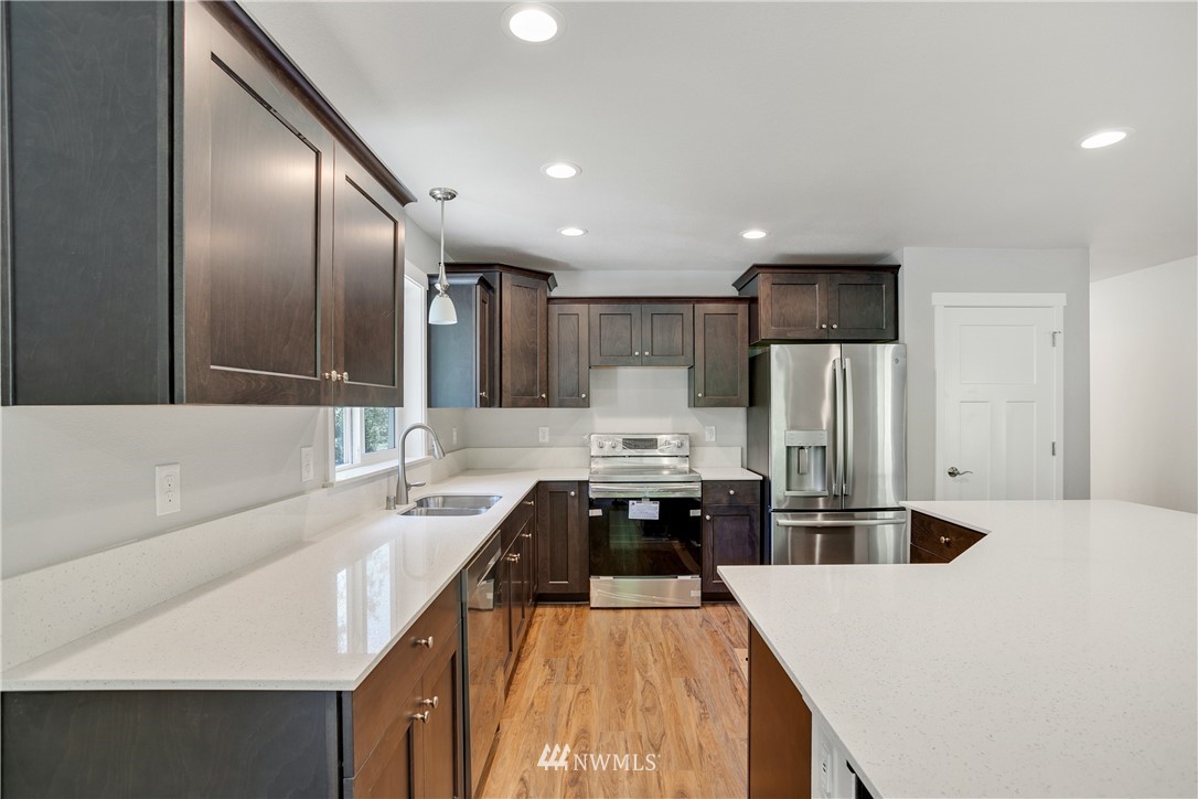 7907 175th Avenue Southwest Rochester, WA 98579 - Photo 20 of 39 a kitchen with stainless steel appliances a refrigerator sink and stove
