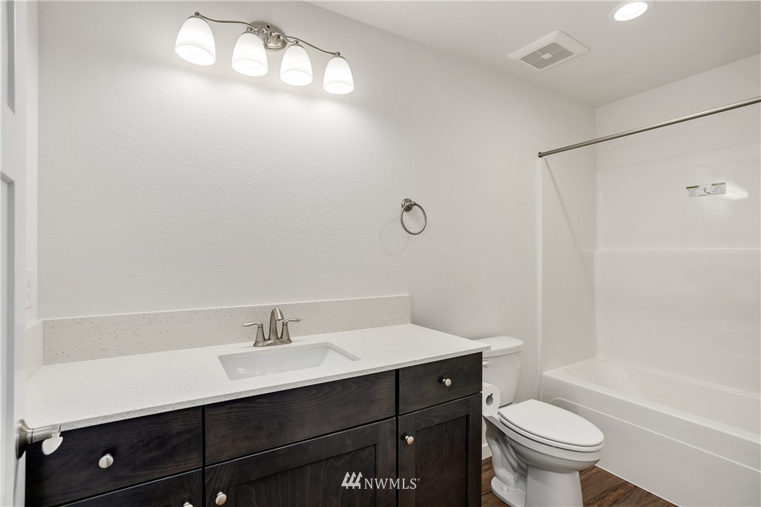 7907 175th Avenue Southwest Rochester, WA 98579 - Photo 28 of 39 a bathroom with a sink toilet a mirror and shower