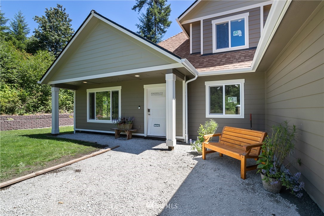 7907 175th Avenue Southwest Rochester, WA 98579 - Photo 4 of 39 a backyard of a house with wooden floor and outdoor seating