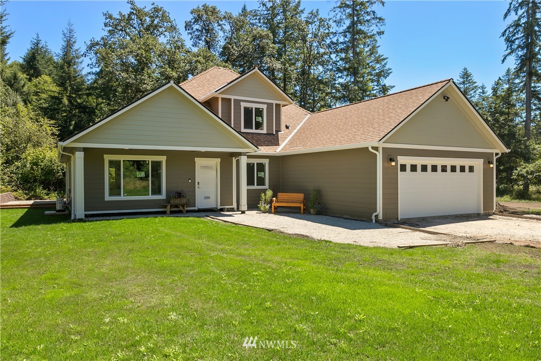7907 175th Avenue Southwest Rochester, WA 98579 - Photo 5 of 39 a front view of a house with a garden and yard