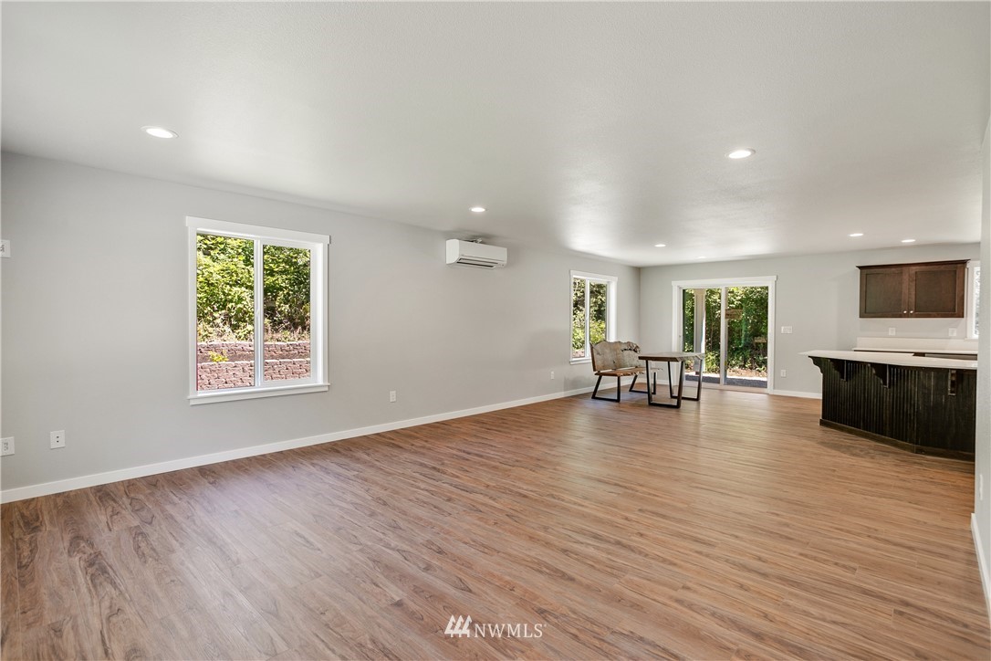7907 175th Avenue Southwest Rochester, WA 98579 - Photo 8 of 39 a view of a livingroom with wooden floor and furniture