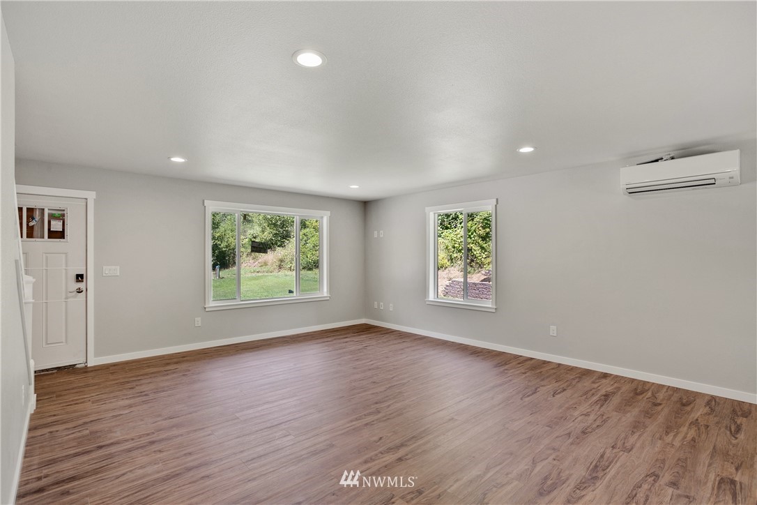 7907 175th Avenue Southwest Rochester, WA 98579 - Photo 10 of 39 wooden floor in an empty room with a window