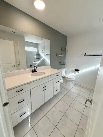 a spacious bathroom with a double vanity sink mirror and toilet