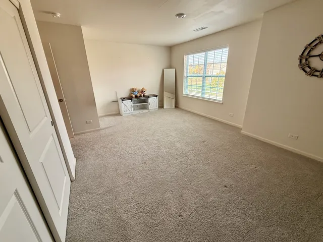 a view of hallway with furniture and a window