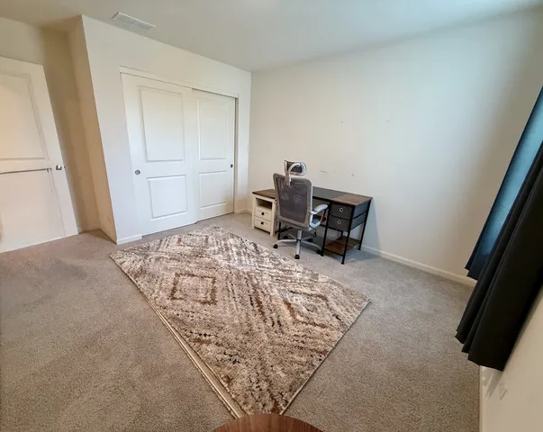 a bedroom with a bed and chair