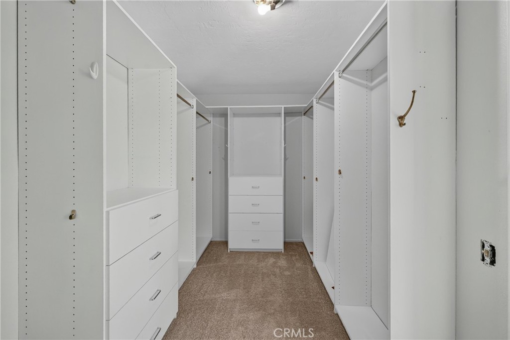 2935 Bluebell Avenue Brea, CA 92821 - Photo 23 of 38 Primary bathroom includes a walk-in shower, dual sinks, dedicated vanity space, and a spacious walk-in closet, creating a comfortable private retreat