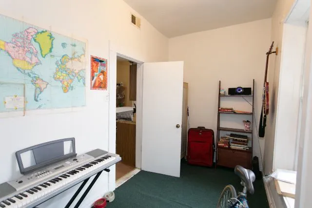 a bedroom with a bed and a workspace