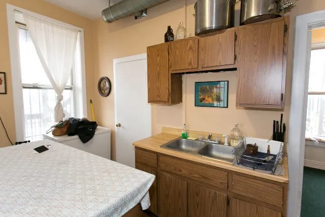 a kitchen with a sink a stove and cabinets