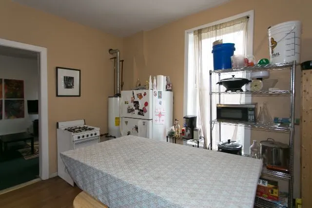 a bedroom with a bed and a tv on the table