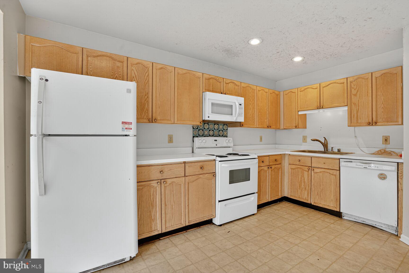 13920 Baton Rouge Court Centreville, VA 20121 - Photo 6 of 24 a kitchen with granite countertop appliances a sink and a refrigerator